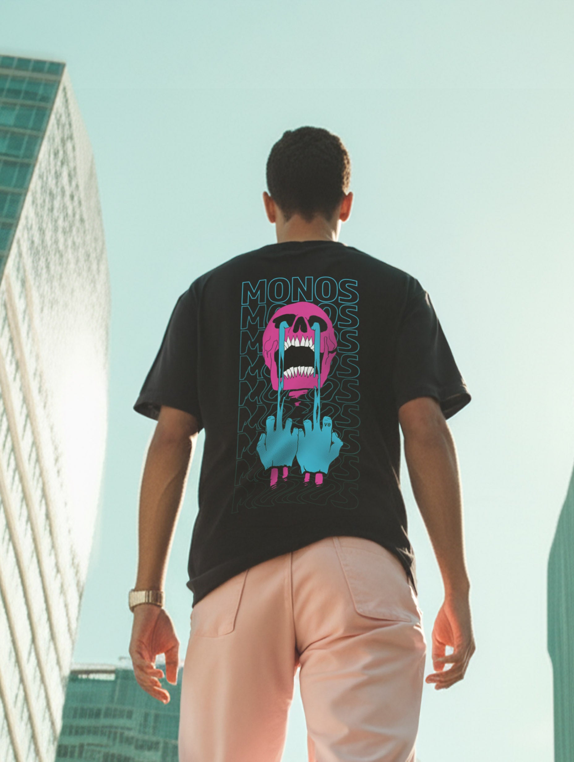 Person wearing a black t-shirt with colorful graphic design outdoors